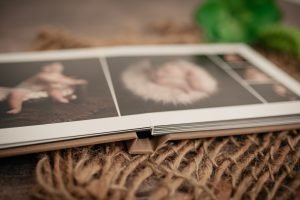 Vancouver Newborn Photographer - Close up of an album with pictures of a baby
