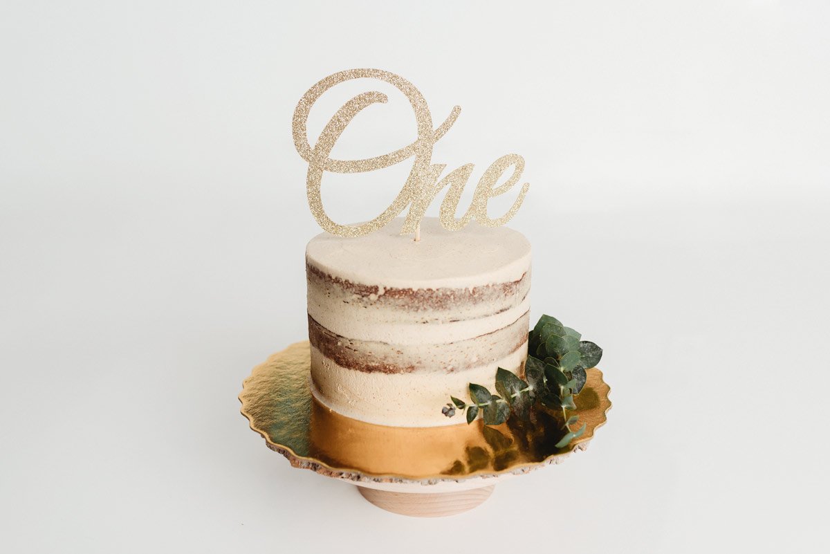 North Vancouver Newborn Photographer - Cake for cake smash with a gold one as topper