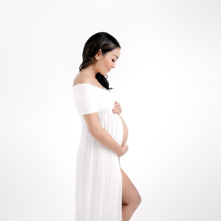 Maternity Photography Vancouver - pregnant woman posing on white background